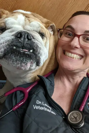 a person and a dog posing for the camera